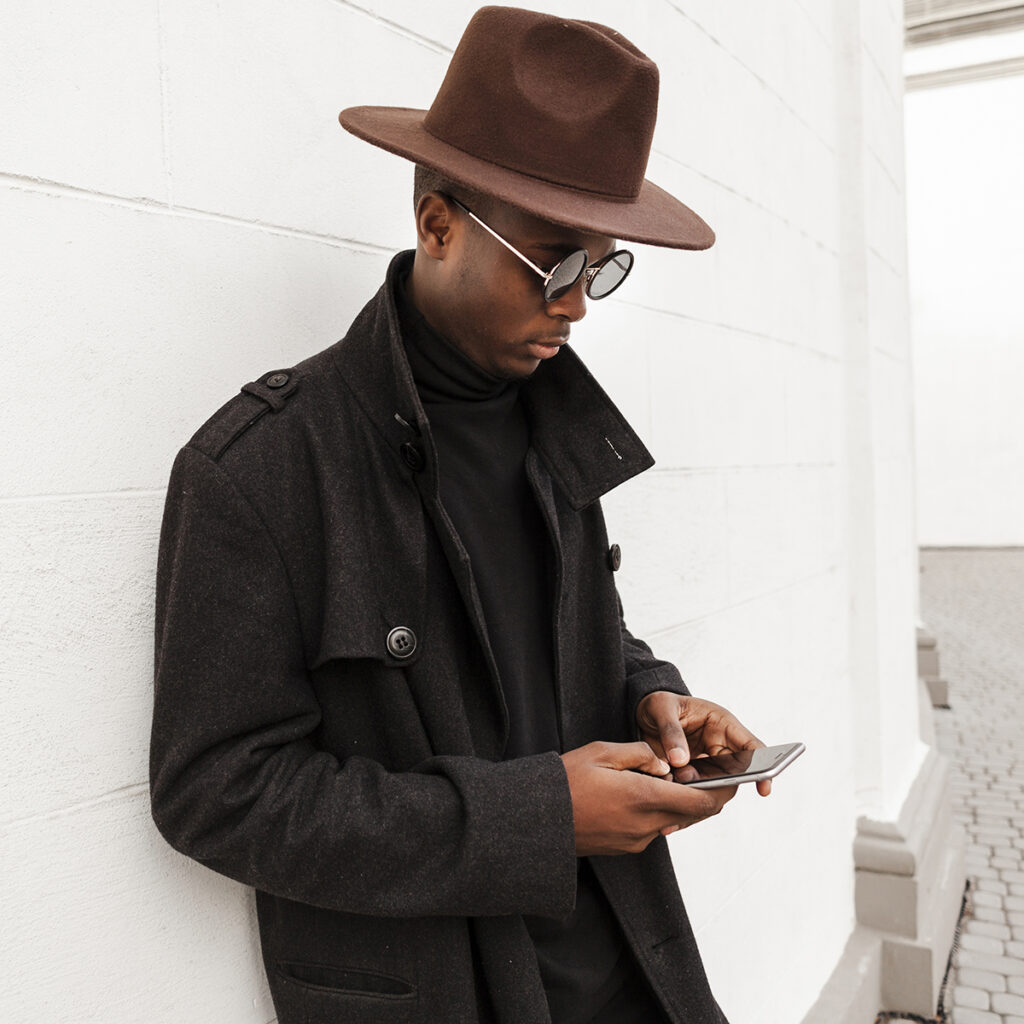 handsome young male texting his mobile phone